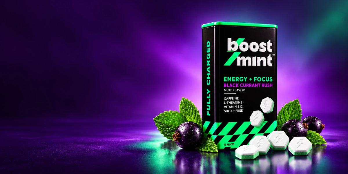 BoostMint Blackcurrant Rush concept tin with mints, mint leaves and blackcurrants in purple and green studio lighting